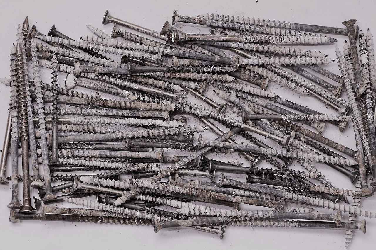 long used screws piled together